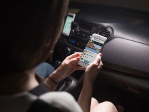 passenger viewing smartphone in car